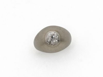 un gros plan sur une pierre unique sertie d'un diamant