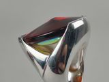 an image of a silver ring with a red stone on it