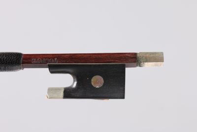 a violin bow that is attached to a piece of wood