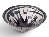 a black and white bowl with flowers in it