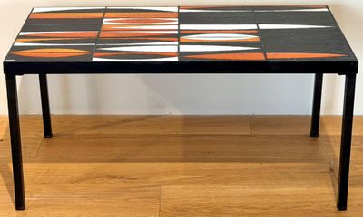 a black table with orange and white tiles on it