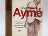 a book with a picture of a man standing next to it