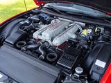 a red car with its hood open and the engine in it