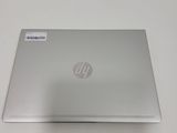the back of a laptop computer sitting on top of a white table