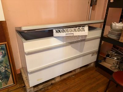 a picture of a white dresser in the corner of a room