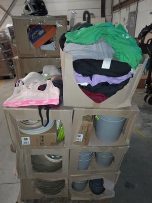 a cart full of clothes and other items in a warehouse