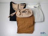 three pairs of women ' s pants are lined up on a shelf