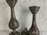 two metal candlesticks sitting on a table