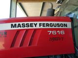 a close up of a red tractor with the name massey ferguson on it