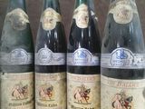 six bottles of wine are lined up on a table