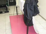 a pink mat on the floor with a black coat hanging on it
