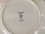 a white plate with a green and pink design on it