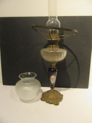 a lamp that is sitting on a table next to a vase