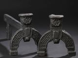 pair of antique iron horseshoes on a black background
