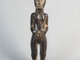 an image of a wooden statue of a man with a hat on his head