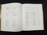 a book open to a list of items on a table
