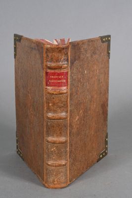 an old book that is open on a gray surface