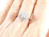 an image of a woman ' s hand holding a diamond and white gold ring
