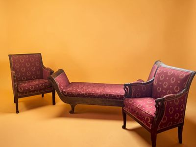 two chairs and a bench in a room with a yellow wall