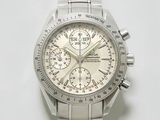 une montre en argent avec un cadran blanc posée sur une surface blanche