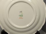 a white plate with a green and yellow design on it