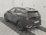 the rear end of a gray car parked in a garage