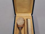 a small blue box with a comb, comb, and a comb in it
