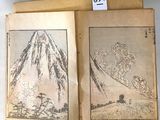 an old book with a picture of a mountain in the middle of it