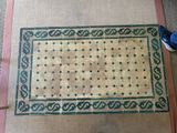 a rug on the floor next to a pair of shoes