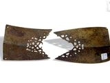 two pieces of rusted metal with holes cut out of them