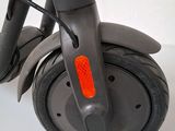 a scooter that is sitting on a white surface