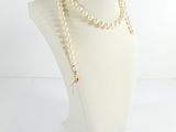 pearl necklace on mannequin head with gold clasp