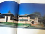 an open book with a picture of a house on it