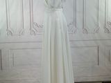 a photo of a white dress on a mannequin stand