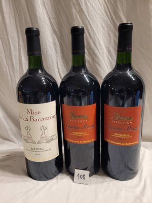 three bottles of red wine are lined up on a table
