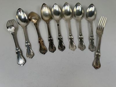a lot of silver spoons and forks on the table