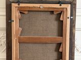 an old wooden frame with a picture hanging on the wall