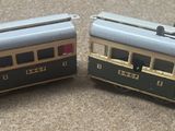 two toy trains sitting side by side on the floor