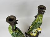 two green birds that are sitting on top of each other