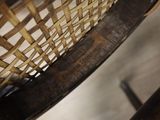 a close up view of a chair with a woven seat