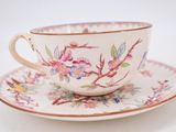 a cup and saucer on a saucer on a white table