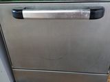 an image of a stainless steel dishwasher sitting on a pallet