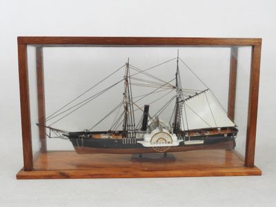 maquette de bateau dans une vitrine en verre posée sur un socle en bois