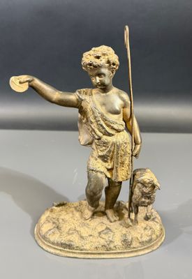 une image représentant la statue d'un garçon avec un chien