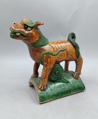 an image of a figurine of a dog on a green base