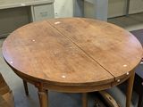 a wooden table with two chairs in a room