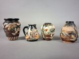 three vases with different designs are lined up on a gray surface