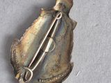 a silver brooch with a pin on it