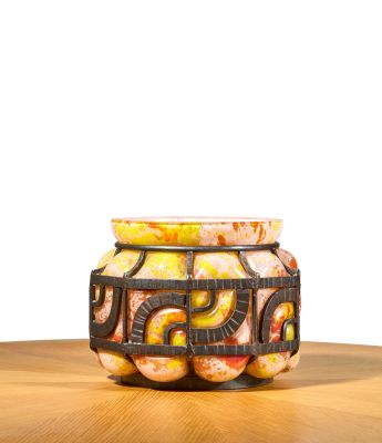 a vase that is sitting on a table with a white background