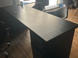 an image of a desk in a room with a large window